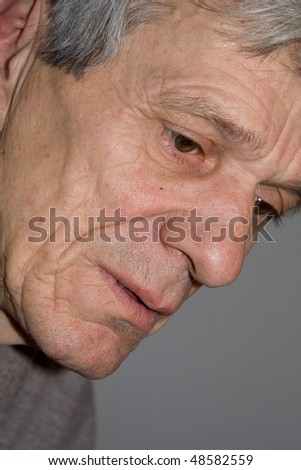 Closeup of a senior man looking away in deep thought
