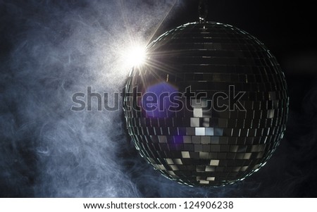 A disco ball with light flare and smoke. A nightlife image to be used as example on party fliers.