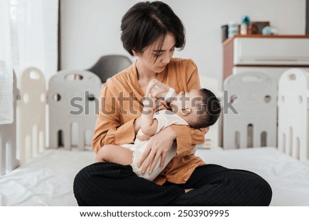 Similar – Image, Stock Photo Newborn drinking milk from a baby bottle, sitting on mom legs outdoors