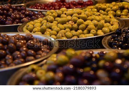 Similar – Image, Stock Photo Olives. A variety of green, black and red olives, with leaves, shot from the top with a place for text