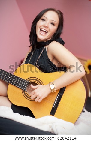 Young beauty music girl with guitar .