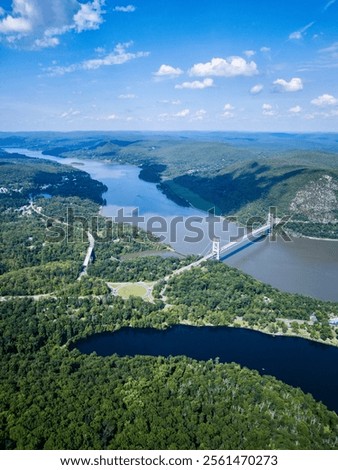 Similar – Image, Stock Photo Bright river landscape under cloudy sky with houses and buildings o city