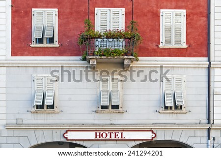 Old hotel building with balcony in Italy