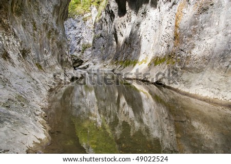 limestone gorge in romanian carpathians mountains calm flowing river water reflection