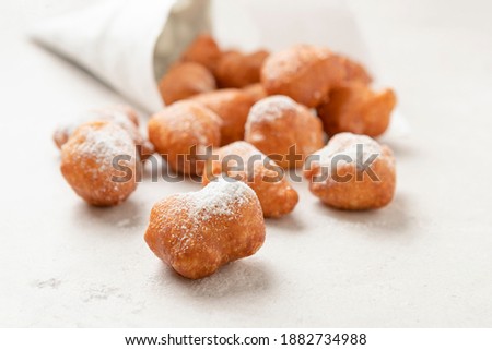 Beignets in a cornet paper bag on a stone surface Stockfoto © 