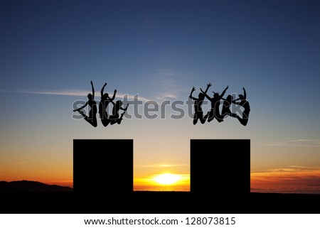 silhouette of friends jumping in towers in sunset