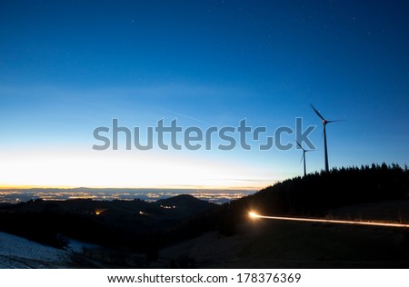 wind power mill over forest at night