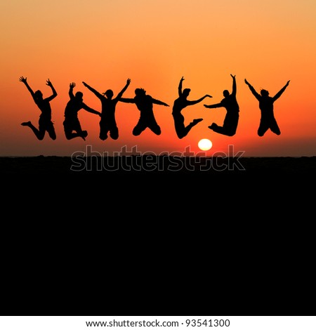 silhouette of friends jumping on beach in sunset