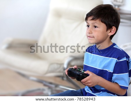 Young Hispanic or Latino boy playing with a video game - with copy space to left