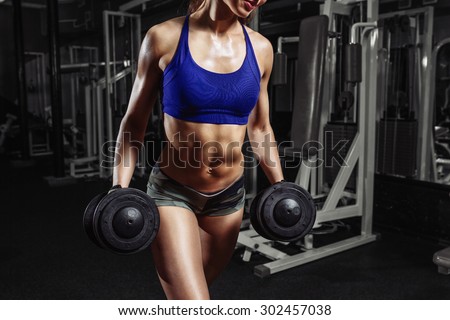 sexy young girl resting after sport workout exercises. Fitness woman in sport wear with perfect fitness body resting in gym