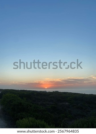 Similar – Foto Bild Die Sonne verschwindet hinter den Bäumen. Hinter dem Haus ist es schon dunkel. Eine starke Bewölkung gibt dem ganzen ein prächtiges Panorama.