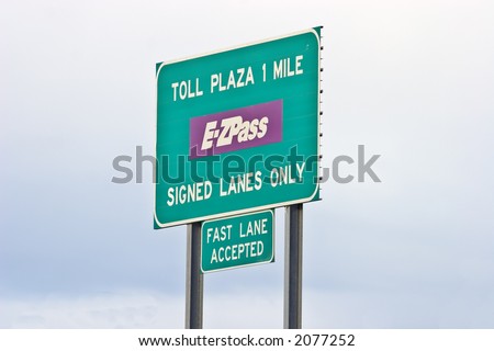 Toll road sign telling of upcoming toll booth plaza