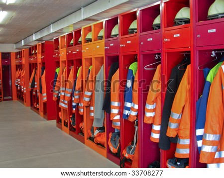 Locker room of a fire department with protection uniforms and helmets.