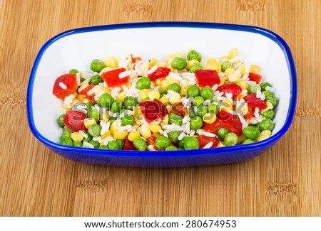 Vegetable mix in blue bowl on wooden bamboo board