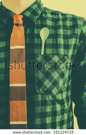 Vintage man with tie and a green spoon in the pocket