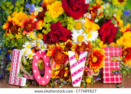Spring flowers and wooden letters LOVE