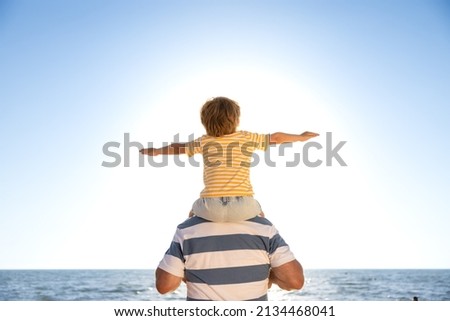 Similar – Image, Stock Photo Rear view child sitting on flower meadow