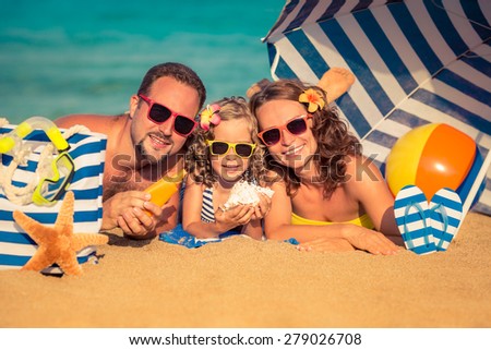 Happy family lying on the beach. Summer vacation concept