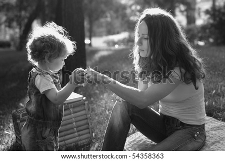 Woman and child having picnic in park - black and white, shallow depth of field