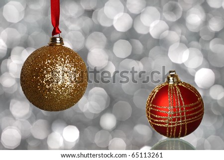 Red and gold Christmas balls on silver blurred background