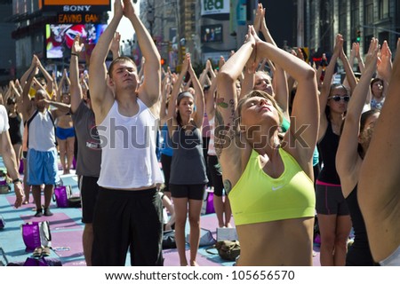 NEW YORK - JUNE 20: A heat wave in Manhattan on the first Day of Summer didn\'t stop the Yoga exercises in Times Square on June 20, 2012.