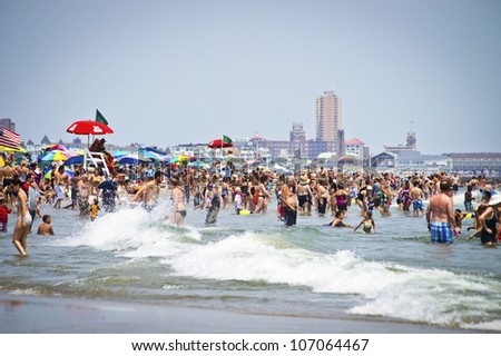 AVON, NEW JERSEY/USA - JULY 7: Big crowds of sunbathers seek relief from the week long heatwave enjoying the surf on July 7, 2012 at the beach in Avon NJ.