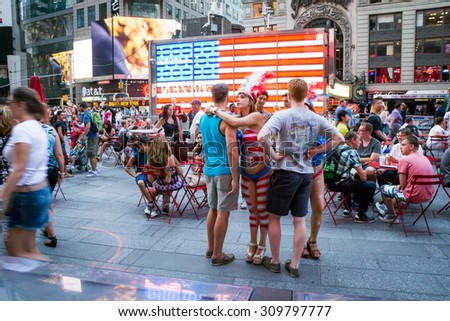 NEW YORK-JULY 22: Topless body painted woman seeking tips in Times Square on July 22 2015 in Manhattan.