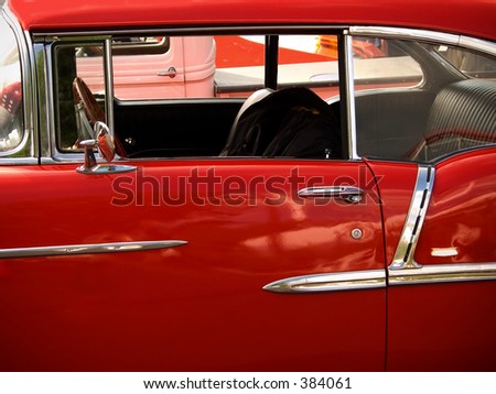 This is a shot of a shiny candy apple red classic car.
