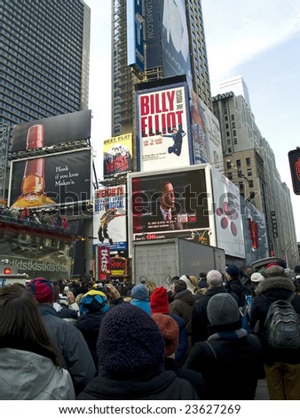 TIMES SQUARE, NEW YORK CITY, JANUARY 20, 2009: Big crowds observe history in Times Square, NY as Barack Obama is inaugurated as the 44th President of the United States.