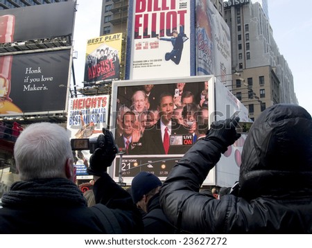 TIMES SQUARE, NEW YORK CITY, JANUARY 20, 2009:  Big crowds observe history in Times Square, NY as Barack Obama is inaugurated as the 44th President of the United States.