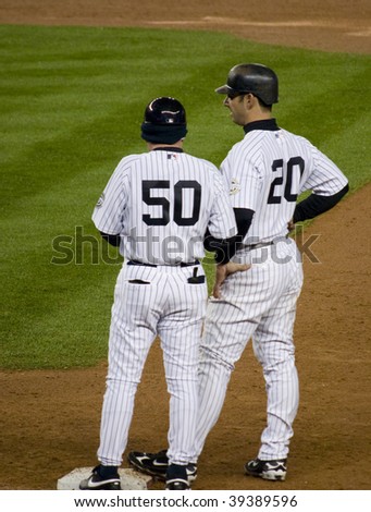 BRONX, NY - OCTOBER 17: Jorge Posada (#20) talks with first base coach Mike Kelleher (#50) during game two of the ALCS at Yankee Stadium on October 17, 2009 in the Bronx, NY.