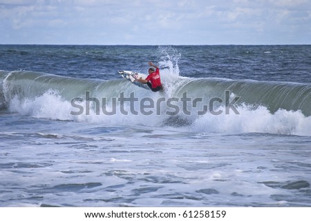 BELMAR, NJ - SEPTEMBER 18: Unidentified surfer catches a wave at The Foster\'s Belmar Pro Surfing contest on Sept. 18, 2010 in Belmar, NJ.