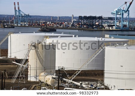 BAYONNE, NJ/USA-MARCH 9: Oil storage tanks and shipping container ports along Newark Bay on March 9, 2012 in Bayonne, NJ. The location is a center for oil storage and international shipping.