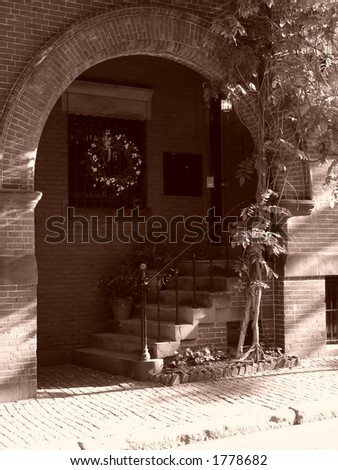 sepia toned arch way entry to home on beacon hill in boston massachusetts