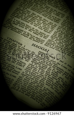 Bible Series. close up detail of antique holy bible open to the book of Haggai in the old testament finished in sepia