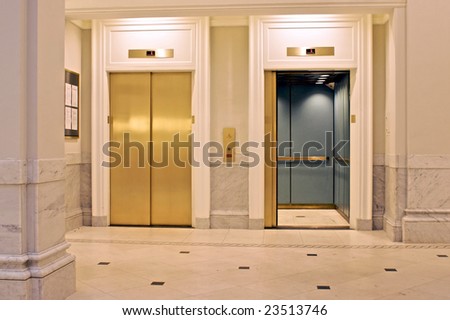 facing twin elevators on first floor, one is open