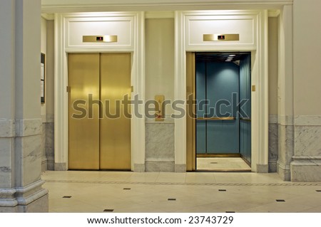 facing twin elevators on first floor, one is open