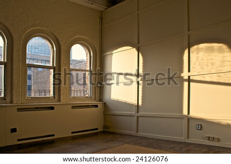 large empty room  in old building with arched windows