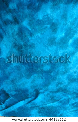 A blue mottled backdrop cloth with wrinkles.
