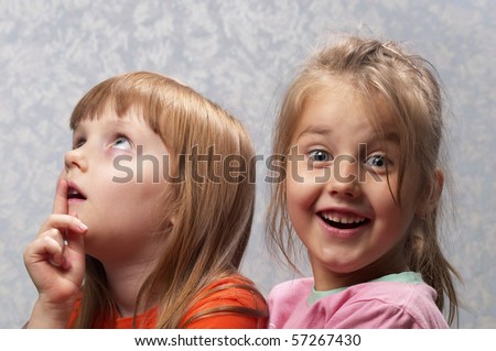 Two little girlfriends thinking and smiling one portrait
