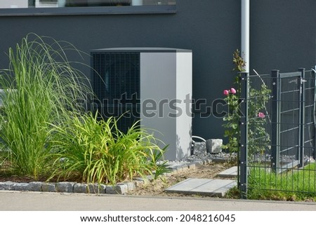 Air-Air Heat Pump for Heating and hot Water in Front of an new built Residential Building Imagine de stoc © 