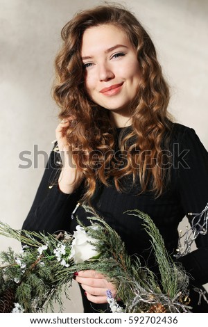 Similar – Image, Stock Photo Young dimpled woman smiles and looks at camera while standing in front of petrol blue wall