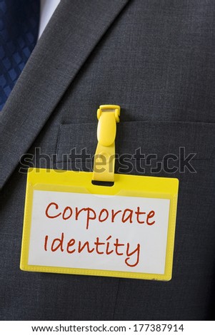Corporate identity sign over a business badge on a dark suit