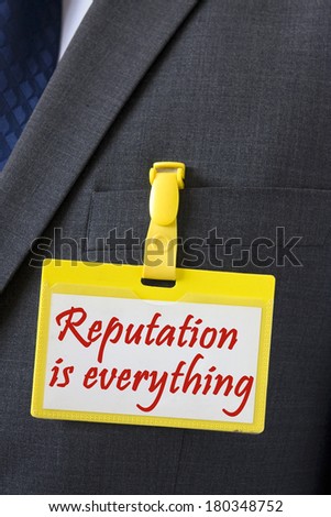 Reputation is everything sign on name card hanging on dark business suit, conceptual image