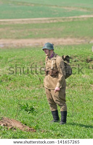 LOSHANY, BELARUS - MAY 5: a military history club member in Soviet Red Army uniform stands during historical reenacting show at Stalin\'s Line memorial on May 05, 2013 in Loshany, Belarus