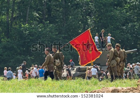 DUBOSEKOVO, RUSSIA - JULY 13: military history club members march with Red Army 322th Rifle Regiment banner during Field of Battle military history festival on July 13, 2013 in Dubosekovo, Russia