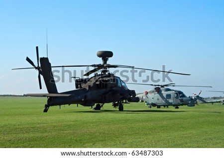 DUXFORD, UK - OCTOBER 10: AH-64d and Westland Lynx helicopters are demonstrated on the flight lane during Autumn Air Show on October 10, 2010 in Duxford, UK