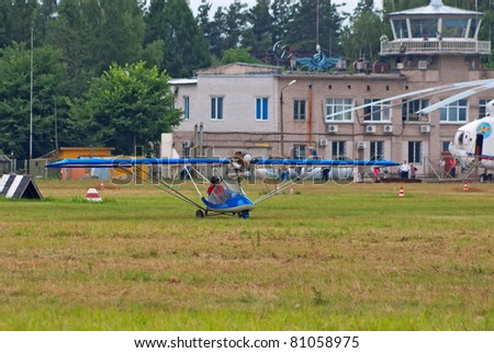 TVER, RUSSIA - JULY 09: An ultralight airplane taxis for takeoff during Tver Blue Skies aviation festival on July 09, 2011 in Tver, Russia