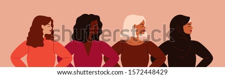 Four women of different nationalities and cultures standing together. Women's friendship, union of feminists or sisterhood. The concept of the female's empowerment movement. 