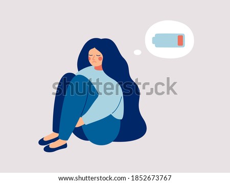 Tired woman sitting and hugging her knees with a discharged battery in the thoughts. Fatigued female is in emotional burnout or mental disorder. Vector illustration